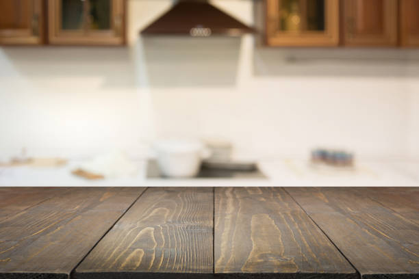istock Blurred background. Empty wooden tabletop and defocused modern kitchen for display or montage your products. 932170960