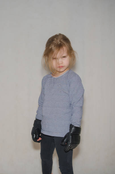 istock child wearing gloves for hand-to-hand combat, ARB 932172028