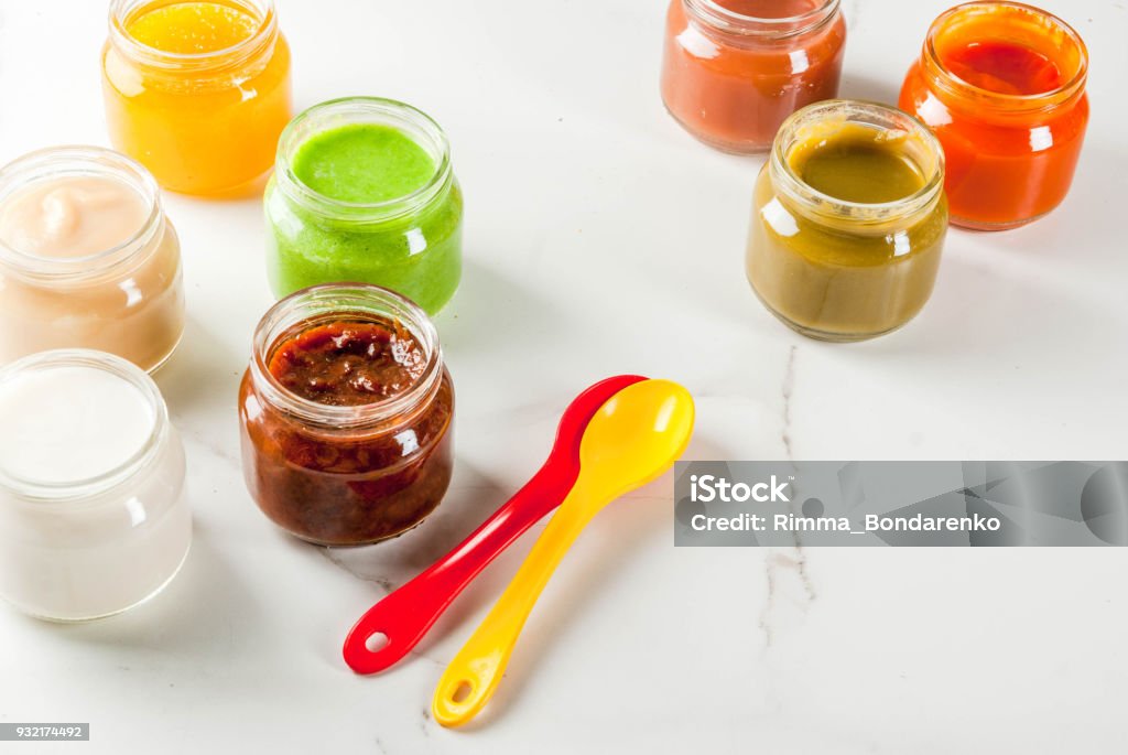 Variety of baby food Variety of homemade baby vegetable and fruit puree,  white marble background copy space Apple - Fruit Stock Photo