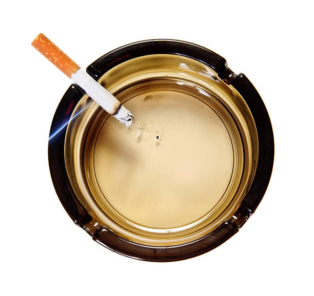 Burning cigarette in ash tray. Top view. Isolated
