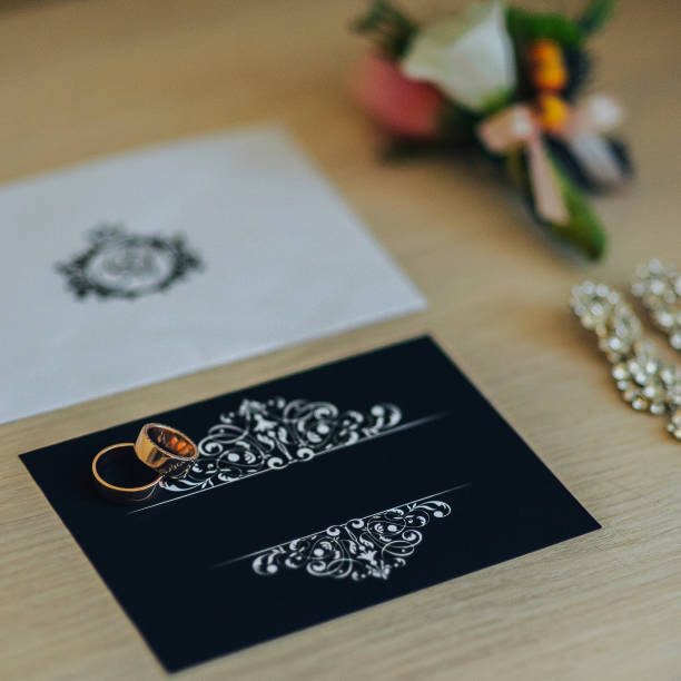 istock Two wedding rings with white flower in the background. 932185670