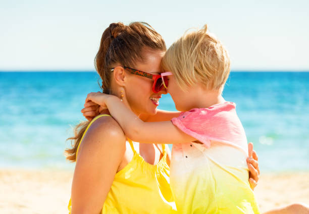 istock happy modern mother and daughter on beach embracing 932186262