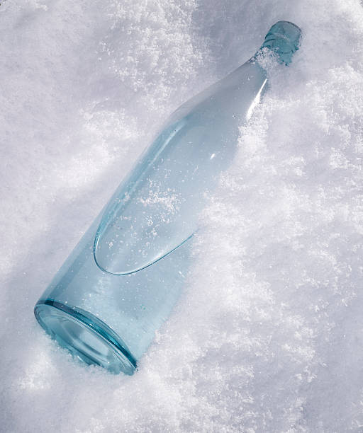 Bottle in the snow stock photo