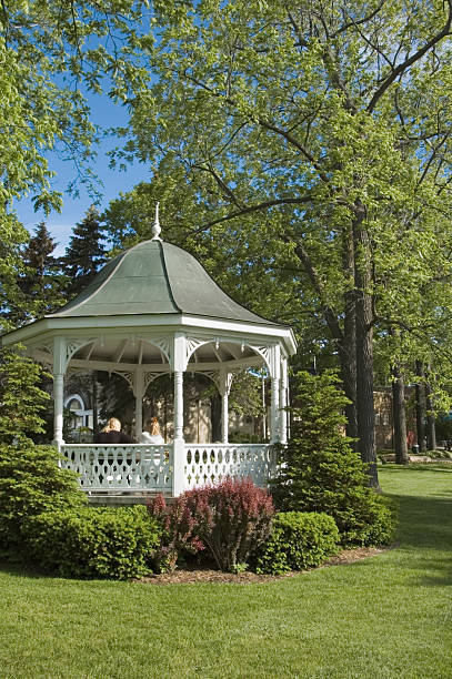 istock White Gazebo in Lush Spring Park Landscape 93219056