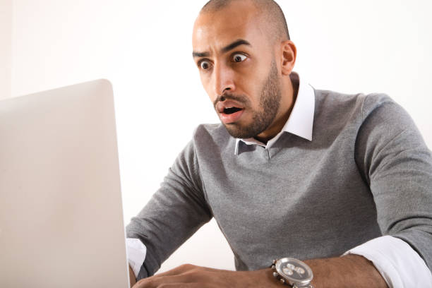 istock Businessman in panic looking at laptop 932193582