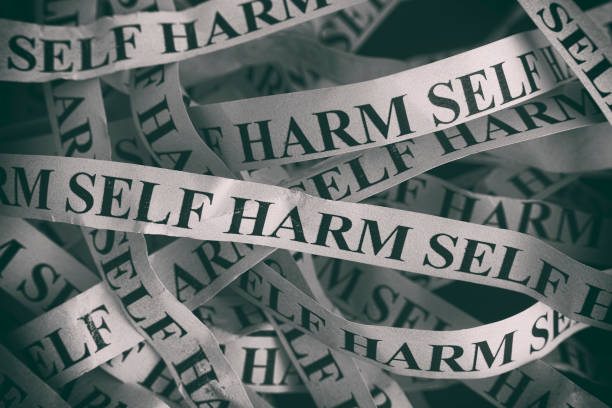Crumpled paper pieces with words Self Harm Crumpled paper pieces with words Self Harm. Black and White. Close up. self mutilation pictures stock pictures, royalty-free photos & images