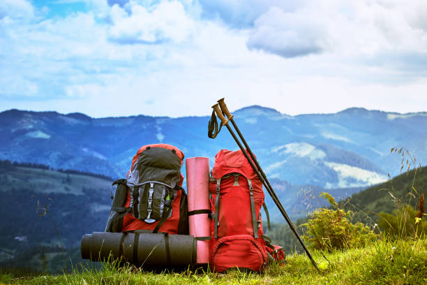 istock Backpacks in the mountains overlooking the mountains on the green grass. 932211096