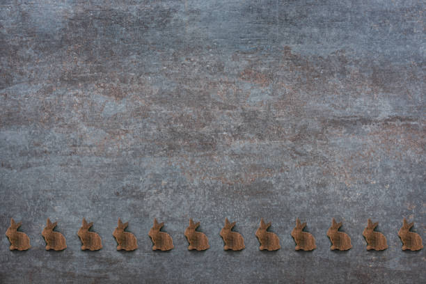 Many little easter bunnies on a gray stone plate for congratulations