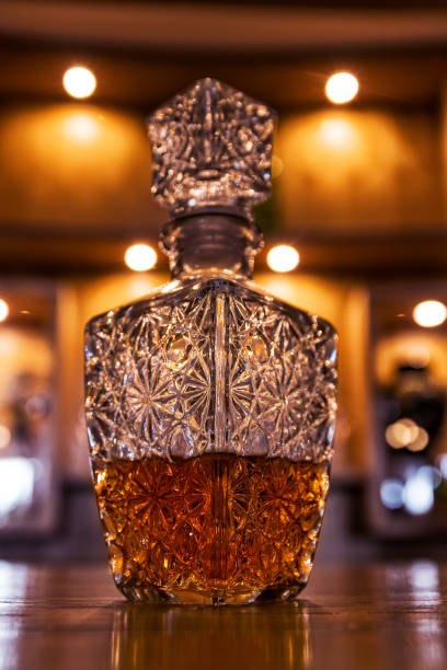 istock Antique whiskey bottle on top of bar counter. 932223672