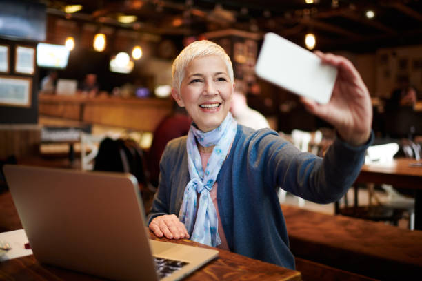 istock Senior woman in coffee shop 932228106