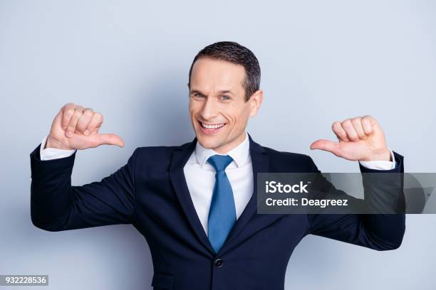 Cheerful Financier Positive Economist Confident Politic Man In Formalwear With Tie Showing With Two Thumbs On Himself Standing Over Gray Background Stock Photo - Download Image Now