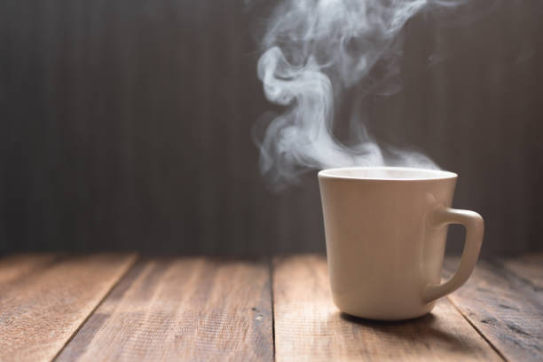istock Close-Up Of Tea Cup With Steam On Table 932236558