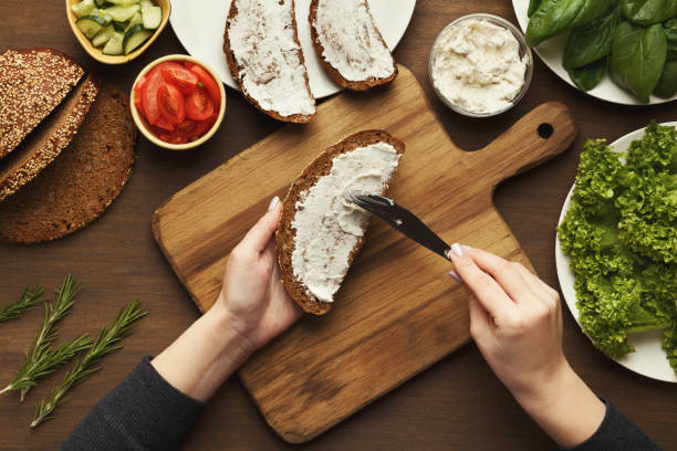 istock Top view on female hands making vegetable bruschettas 932241570