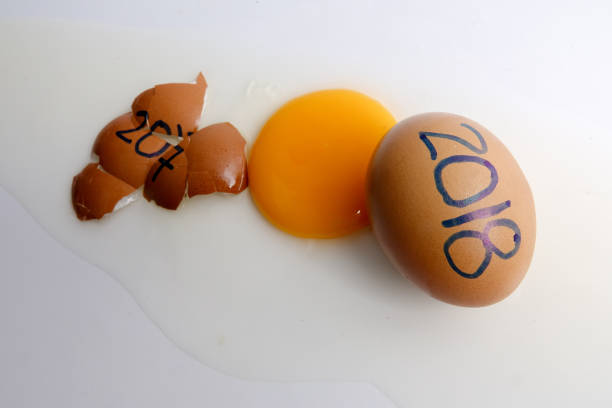 istock Close-Up Of Broken Egg With Numbers Over White Background 932241840