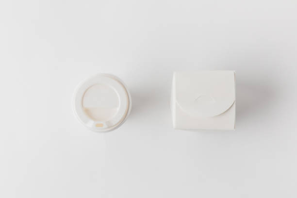 istock top view of disposable coffee cup and noodles box on white surface 932243362