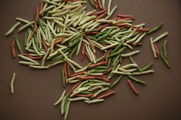 istock Uncooked pasta on paper background, food above 932252072