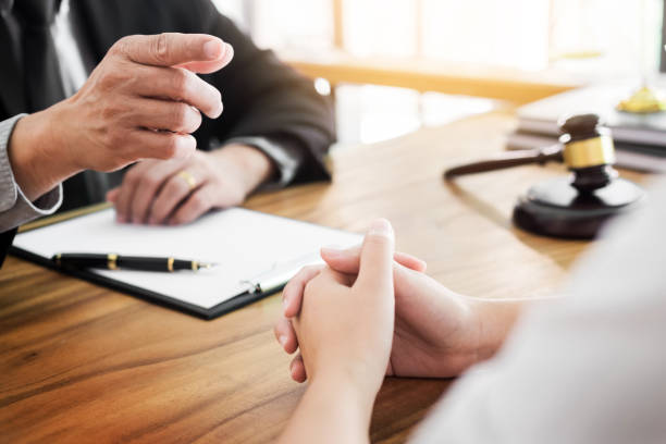 istock Midsection Of Business People Discussing While Sitting At Table In Office 932252128