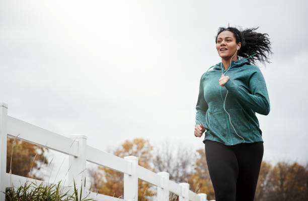 The perfect combo of fresh air and fitness Shot of an attractive young woman going for a run in nature cardiovascular exercise stock pictures, royalty-free photos & images