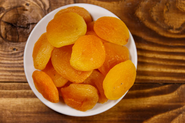 istock Dried apricots on wooden table. Top view 932252766