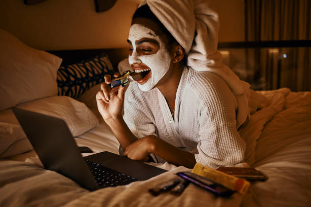 woman relaxing at home using laptop stock photo