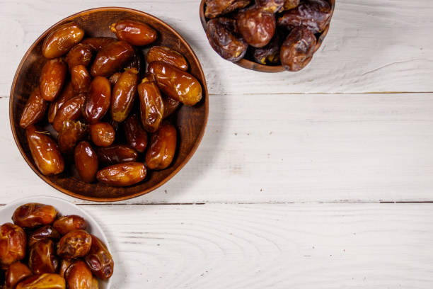 istock Dried dates fruit on white wooden table. Top view 932253498