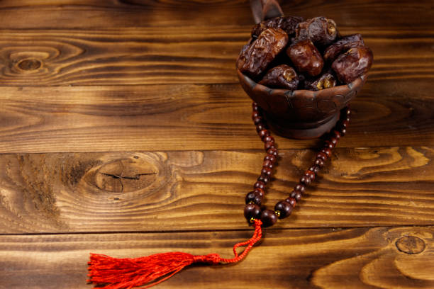 istock Dates fruit and prayer beads on wooden table 932253530