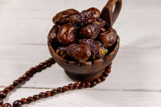 istock Dates fruit and prayer beads on white wooden table 932253536