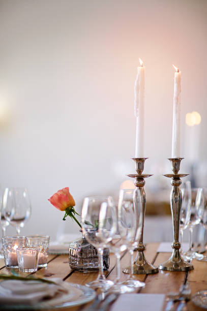 istock Two Candles on a table with a rose at a Wedding Reception 932262714