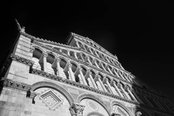 Pisa, Italy - July 28, 2017: Pisa, Tuscany, Italy: the famous Piazza dei Miracoli, with the cathedral, the baptistery and the leaning tower. Facade of Duomo. Black and white