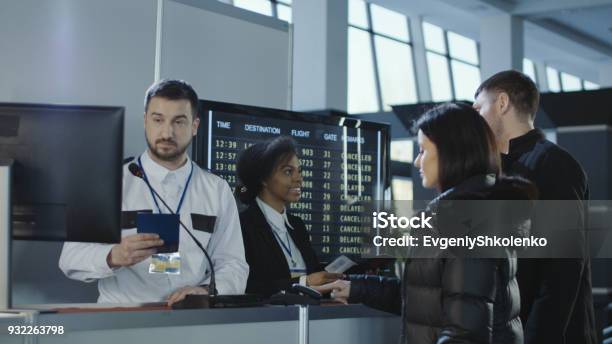 Airport Workers Checking Documents At Control Point Stock Photo - Download Image Now