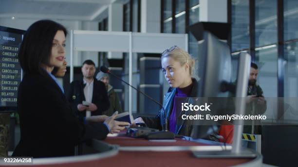 Airport Security Personnel Processing Passengers Stock Photo - Download Image Now - Checkout, Airport, Airport Check-in Counter