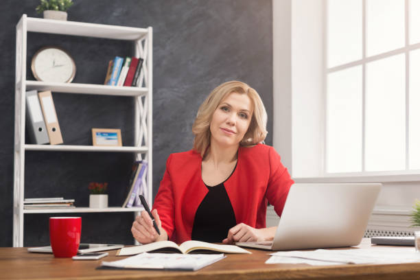 istock Businesswoman working with documents at office desktop 932264958