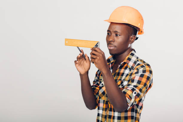 African-American builder uses measuring tape