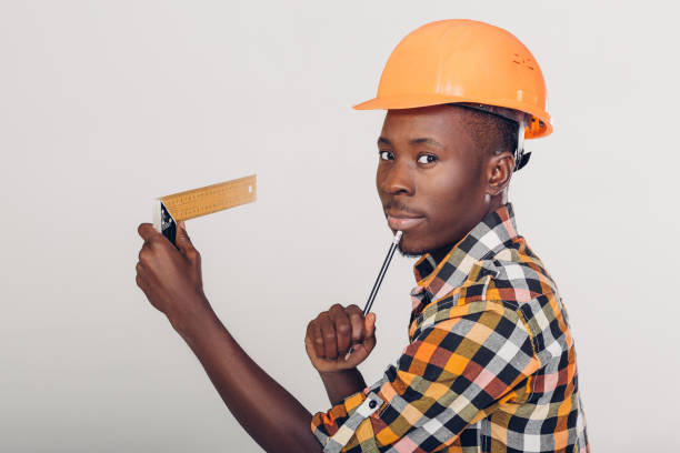 istock African-American builder uses measuring tape 932270780
