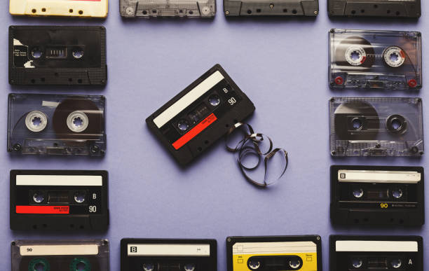 istock Vintage audio cassettes frame on violet background 932271040