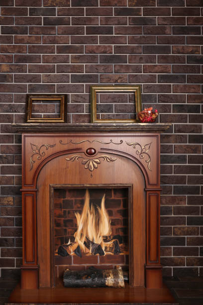 istock Decorative fireplace in the room on a dark brick background 932272558