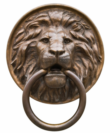 Set of isolated door knockers, gold lion head with the ring on its mouth, antique head and italian traditional doorknobs on white background.  Old ornate metal door handle on the entrance of a house.