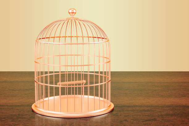 istock Golden bird cage on the wooden table. 3D rendering 932274700