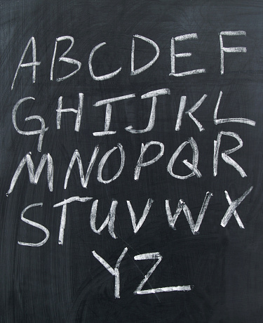 hand written capital letters/alphabet on a chalkboard.