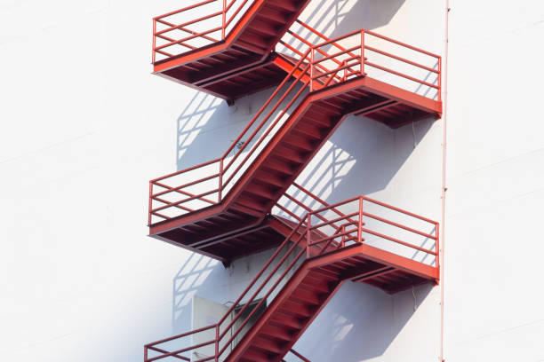istock red fire exit stair, outdoor fire escape ladder 932275550