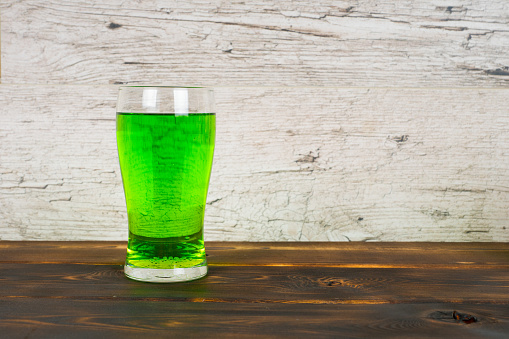 green beer in glass on pub table