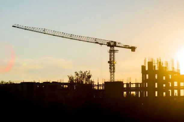 building construction site and crane in deep evening