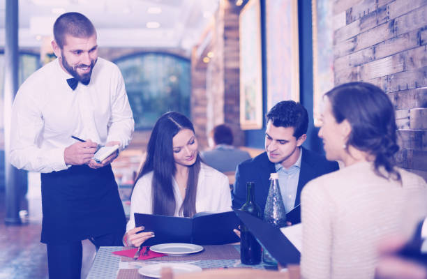 istock Employee waiter man taking order from guests 932279580