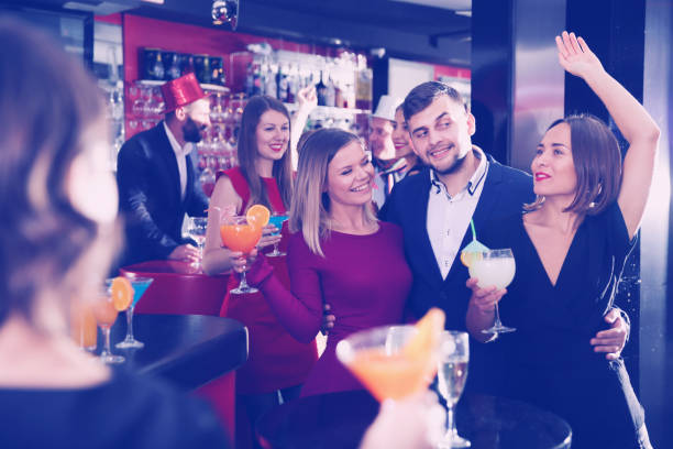 istock Man and two women at nightclub 932280806