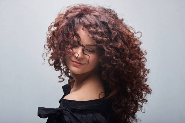 Portrait of young woman with trend curly hair, professional hair coloring stock photo