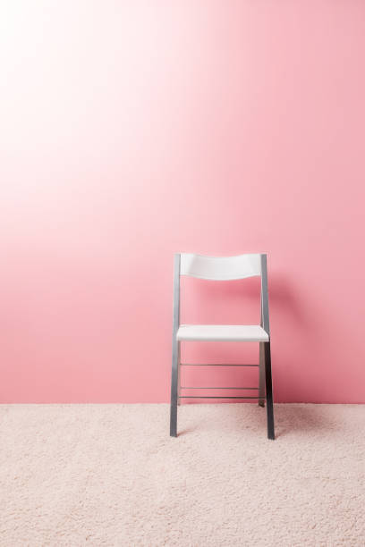 istock foldable chair in front of pink wall 932283868