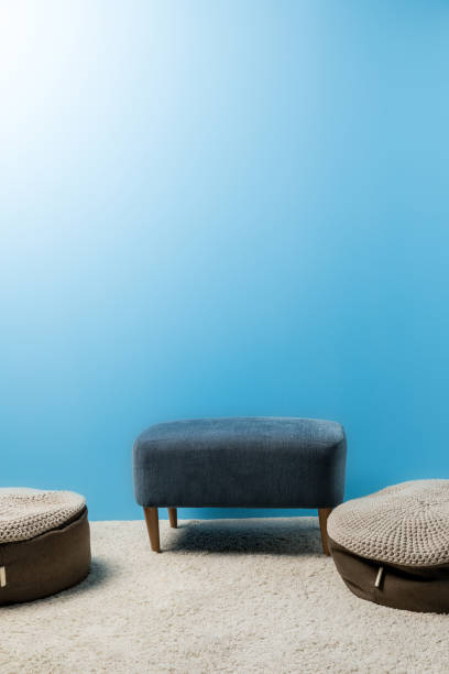 istock comfy hassocks in front of blue wall 932284194