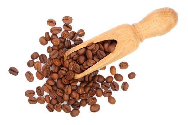istock Coffee beans in wooden scoop isolated on white background top view 932284264