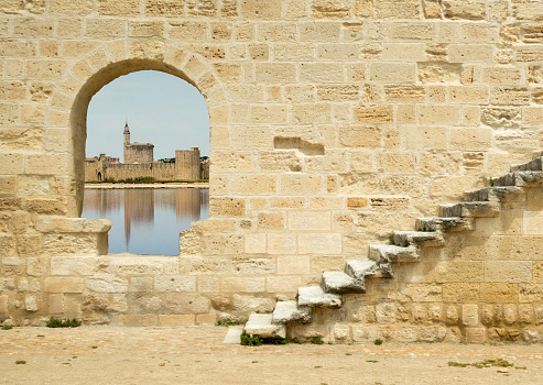 The walls of the medieval town of Aigues Mortes in the distance. The name Aigues-Mortes means 
