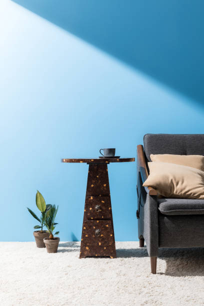 istock coffee table near cozy couch in front of blue wall 932284678